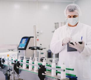 Picture of young man in sterile clothes using tablet
