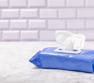 Packaging of wet wipes on background. An open pack of hand and body wipes. Mockup. A clean packet of wet wipes.